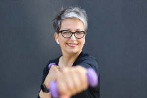 A happy, confident, and healthy senior woman enjoying outdoor recreation, radiating beauty and vitality in nature.