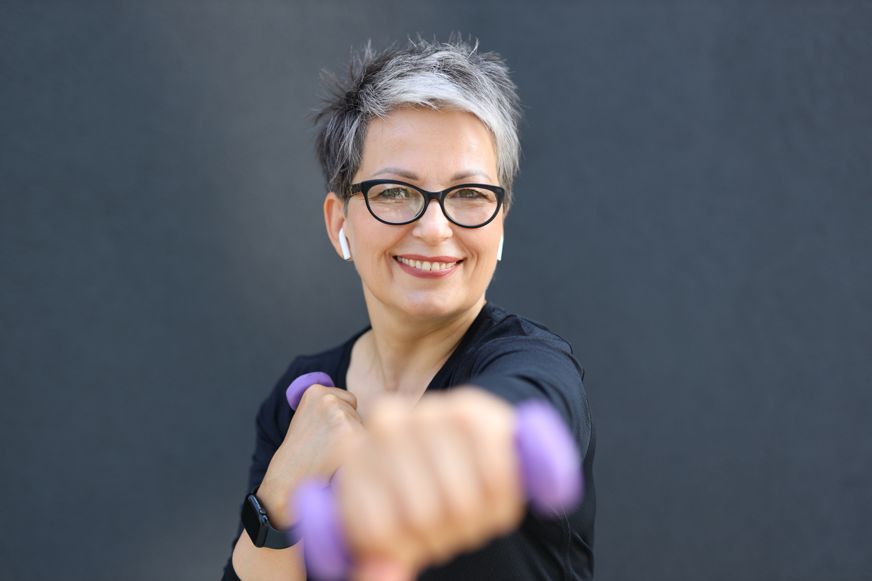 A happy, confident, and healthy senior woman enjoying outdoor recreation, radiating beauty and vitality in nature.